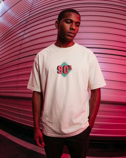 Person wearing a white t-shirt with '90s' design against a pink background