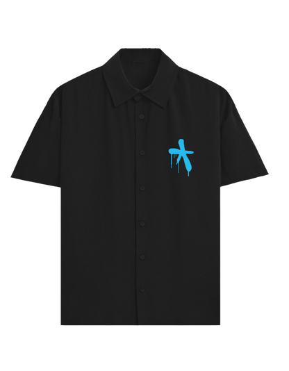 A black short-sleeve button-up shirt with a small blue graffiti-style cross graphic on the left chest, displayed on a clean white background.