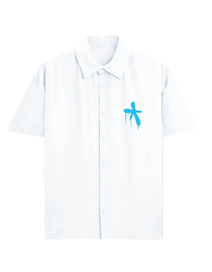 A white short-sleeve button-up shirt with a small blue graffiti-style cross graphic on the left chest, displayed on a clean white background.